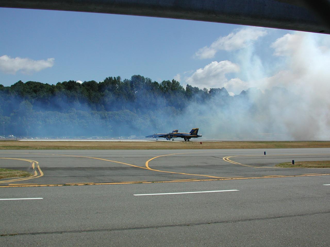 The remaining two Blue Angels coming through the smoke screen