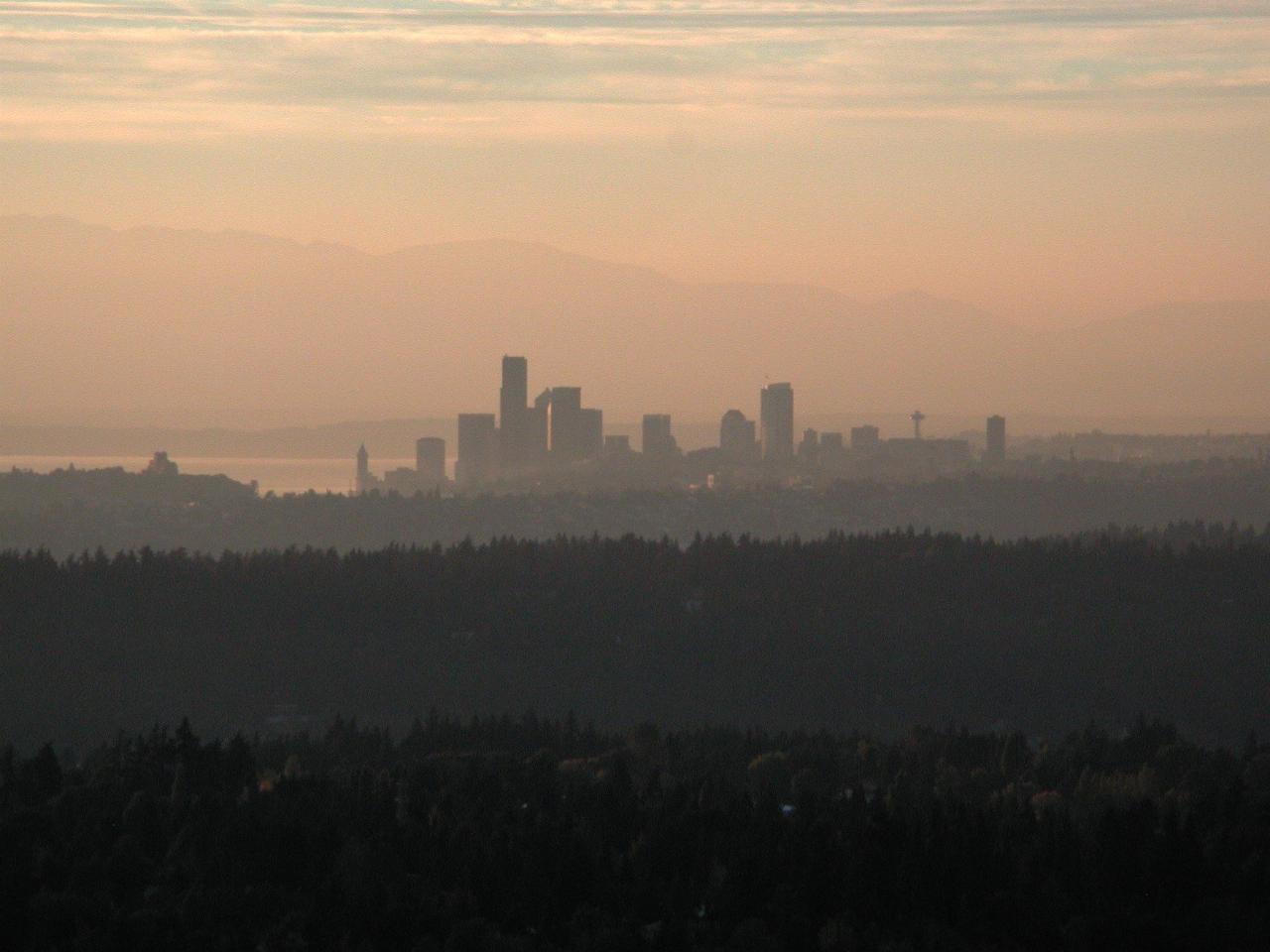 Sunset view of downtown Seattle and Olympic Mountains as seen from Newcastle Golf Club