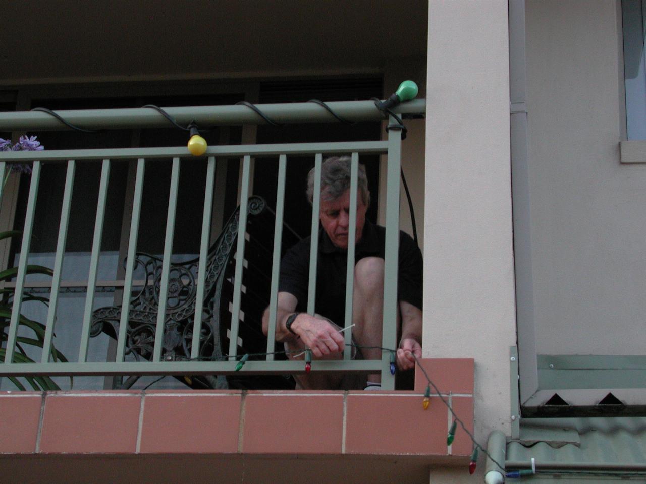 Peter installing Christmas lights on upper deck