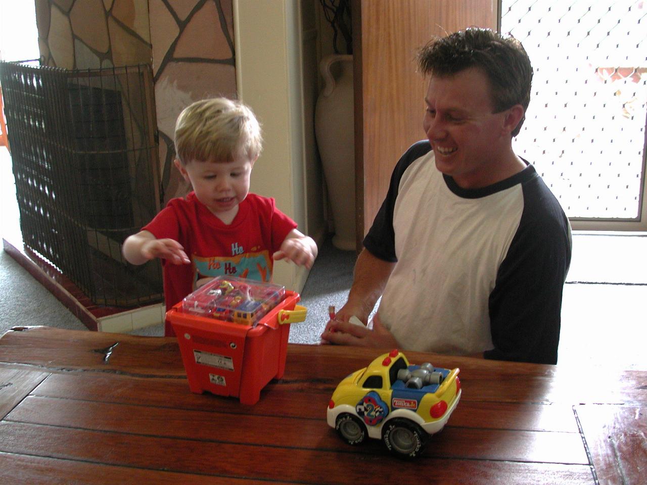 Cameron and Jake unwrapping a new Christmas present