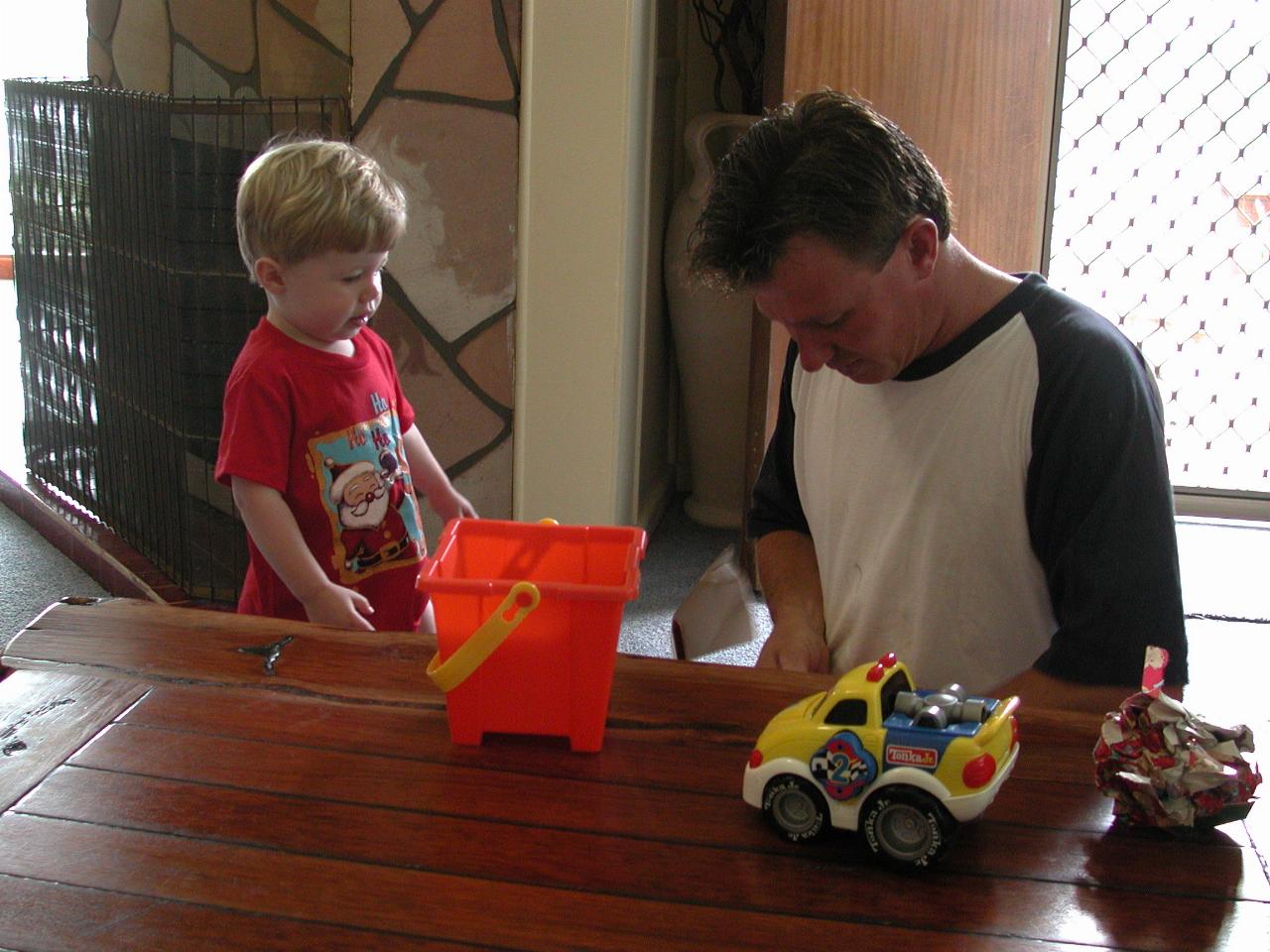 Cameron and Jake unwrapping a new Christmas present