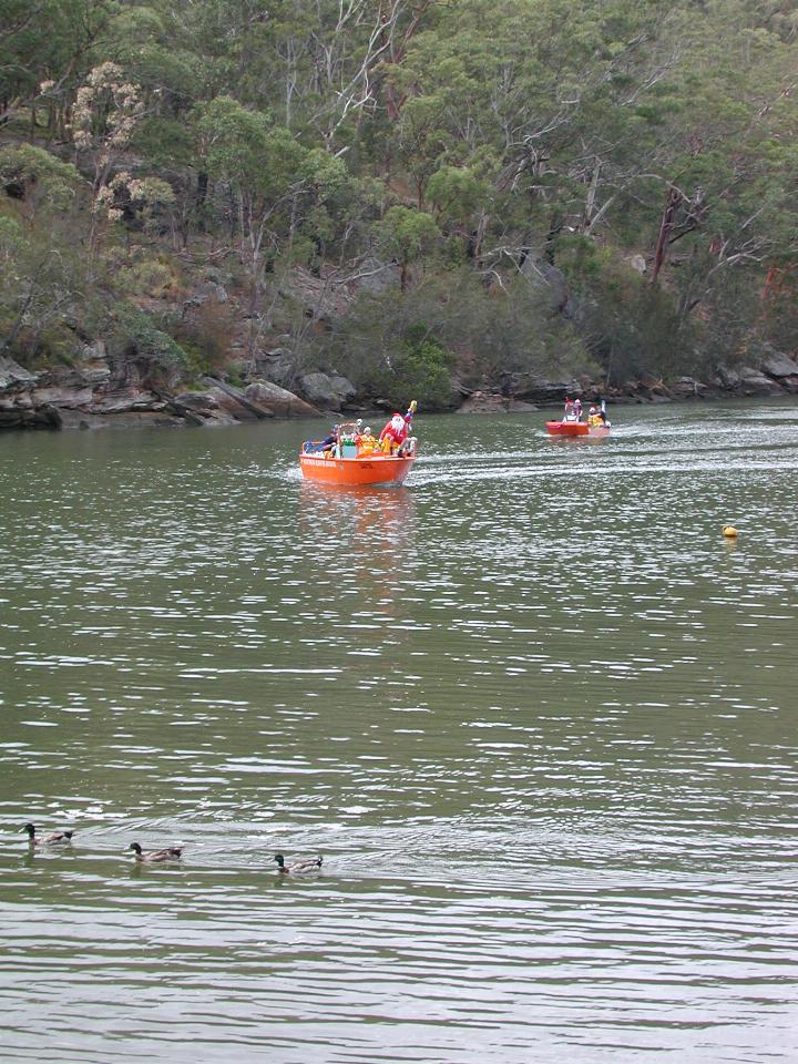 Santa's boat heading in for next stop, as ducks move away