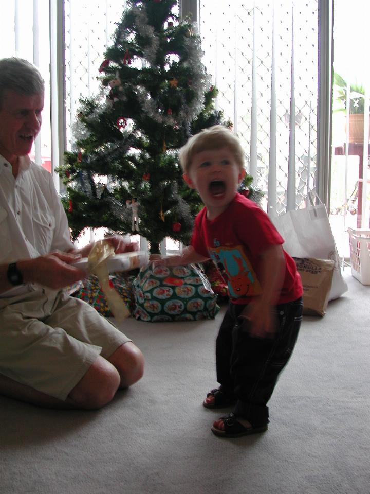 Peter opening one of Jake's Christmas presents at Illawong