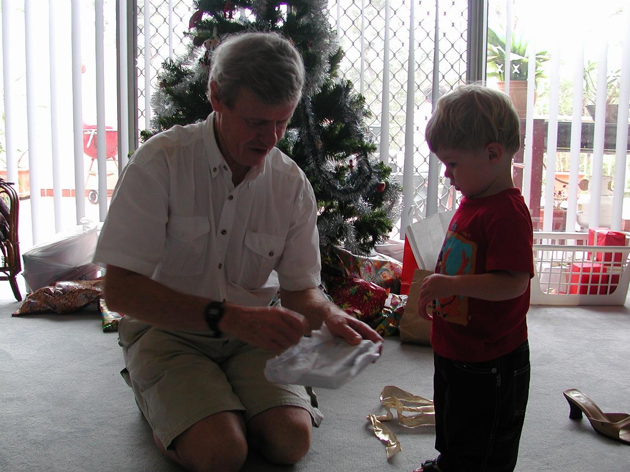 Peter opening one of Jake's Christmas presents at Illawong