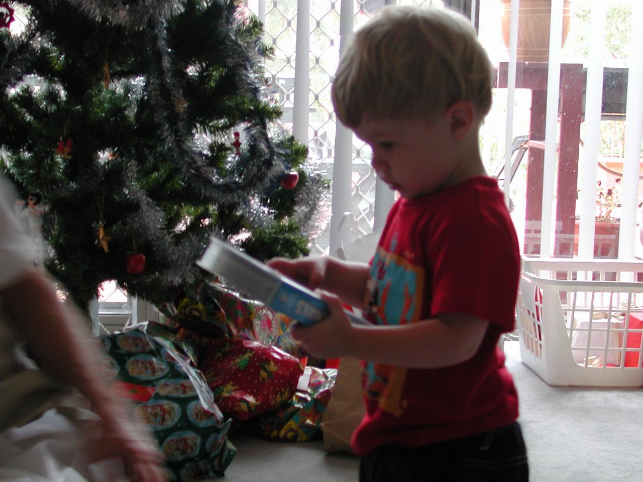 Peter opening one of Jake's Christmas presents at Illawong