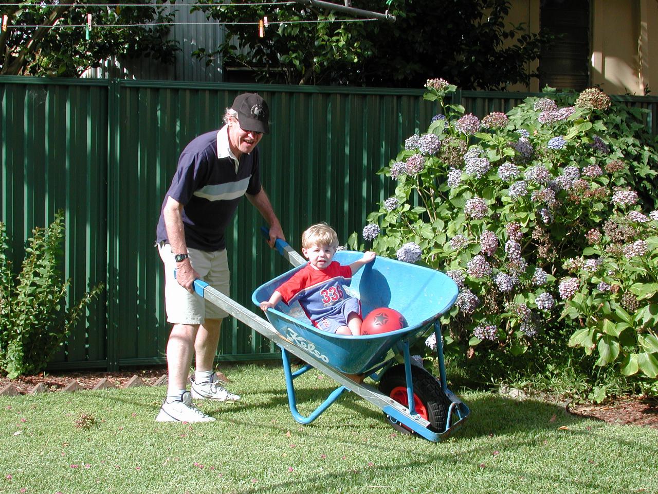 Peter giving Jake a ride in Cameron's wheelbarrow