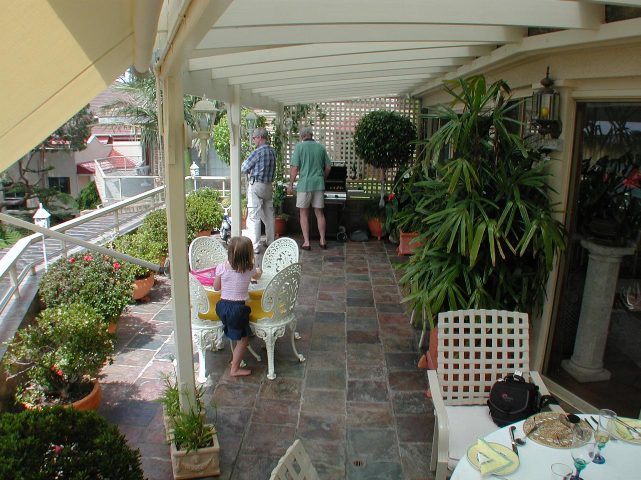 Norm at the barbecue, Peter and Madeline at table on Kuhnert's balcony