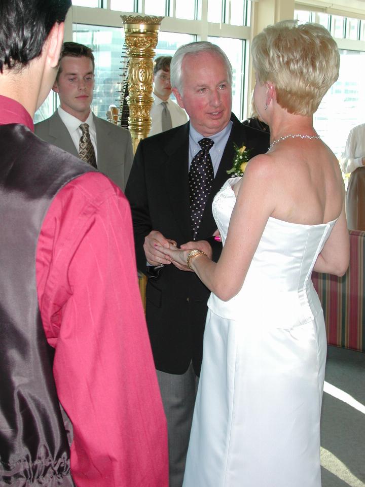 Bill putting the ring on Judy's finger