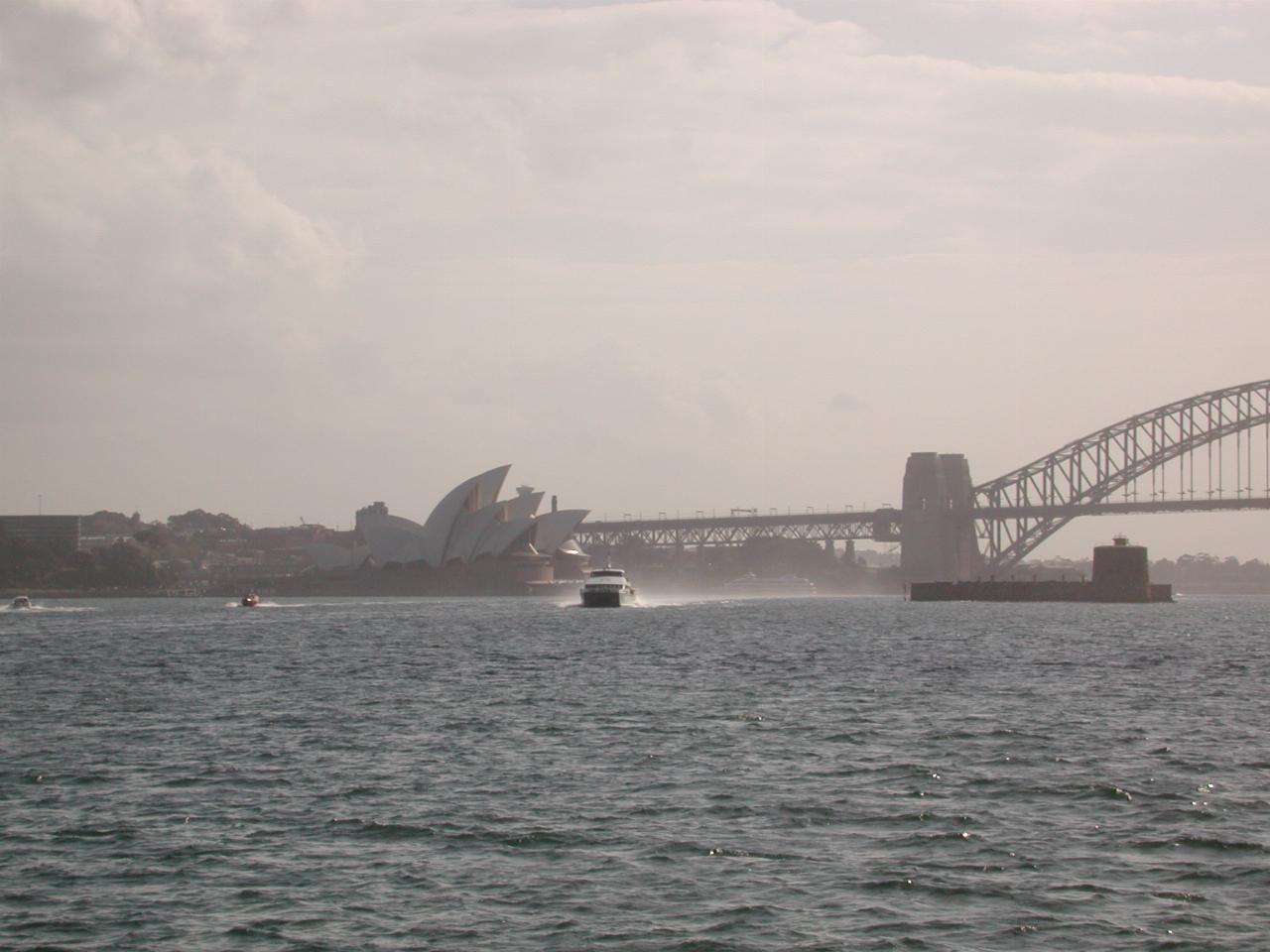 Catamaran Ferry charging past the Opera House and Fort Denison