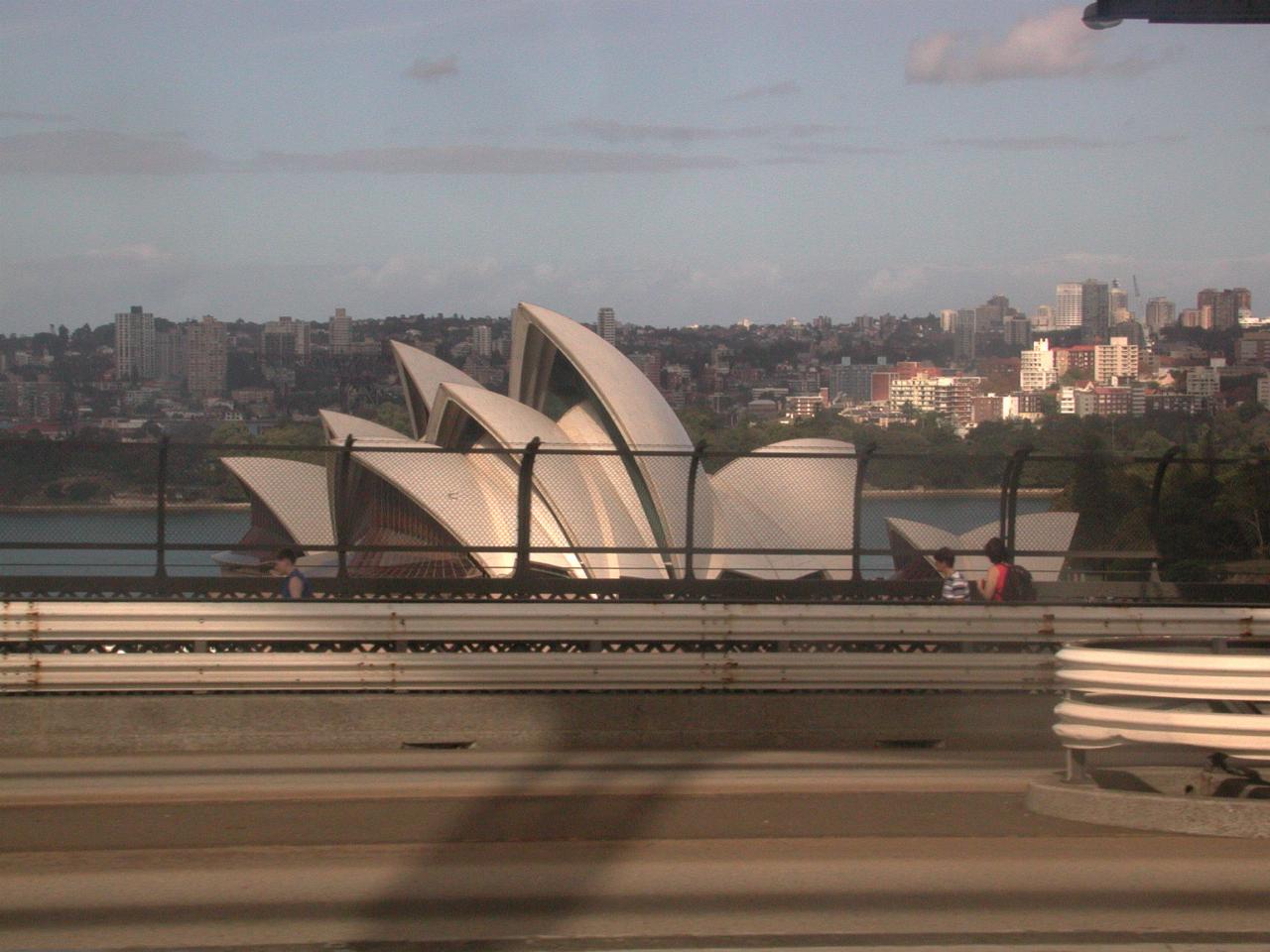 Opera House poking above Harbour Bridge as seen from train