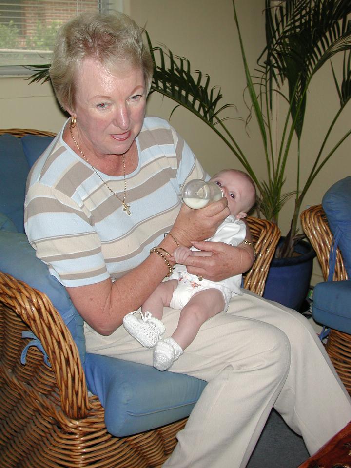 Yvonne (migrain suffering) feeding Flynn on his Baptism day