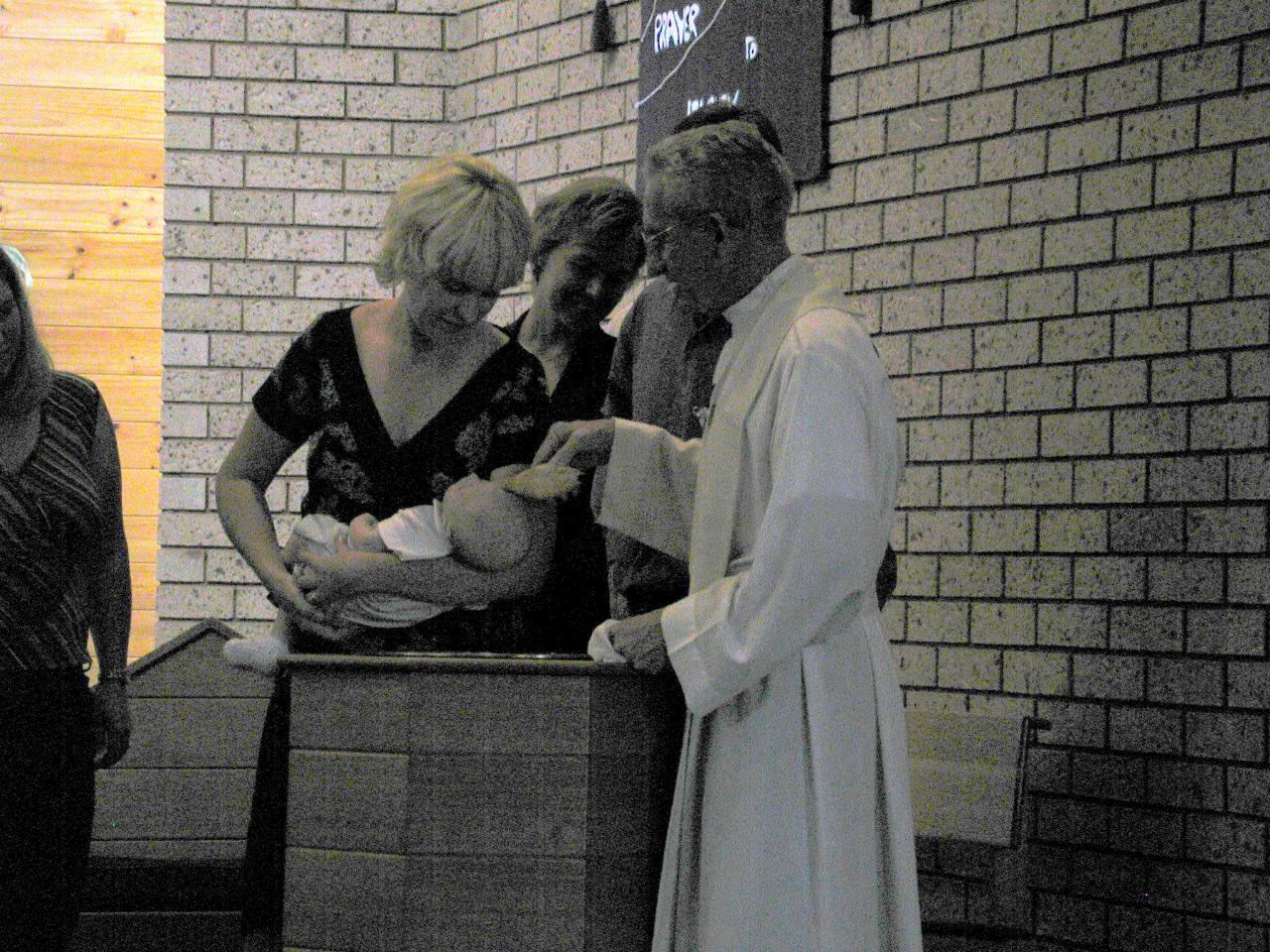 Flynn being Baptised by Father Bob