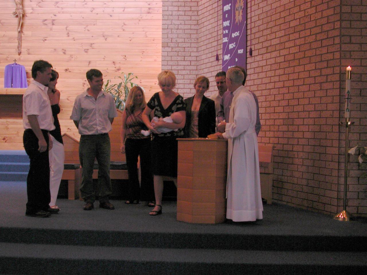 Flynn being Baptised by Father Bob