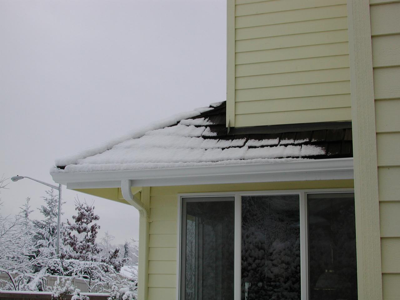 Snow tapering off on the back roof of my home