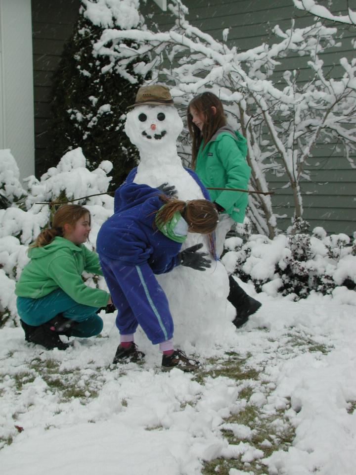 Neighbourhood kids build a good snowman