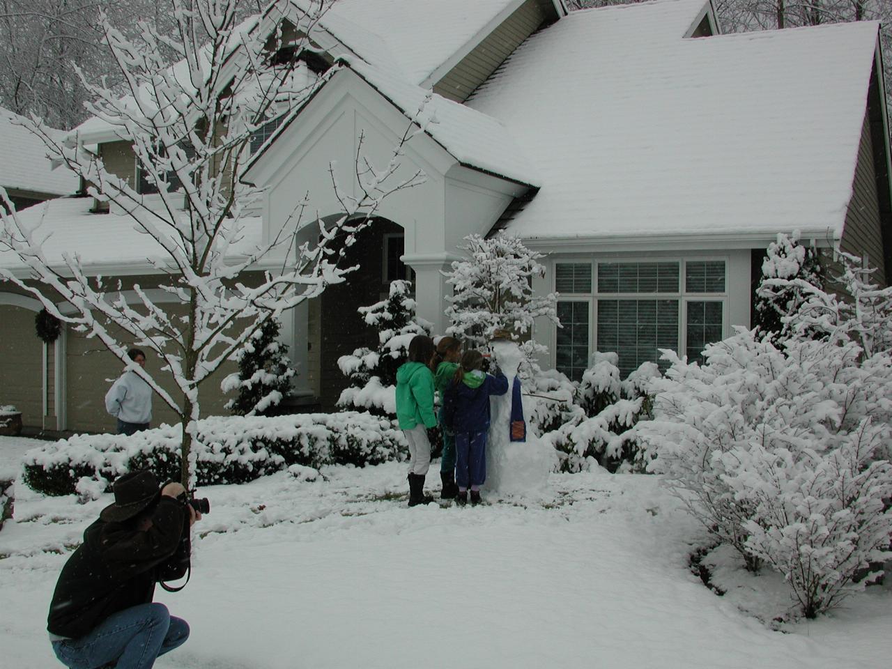 Neighbourhood kids build a good snowman