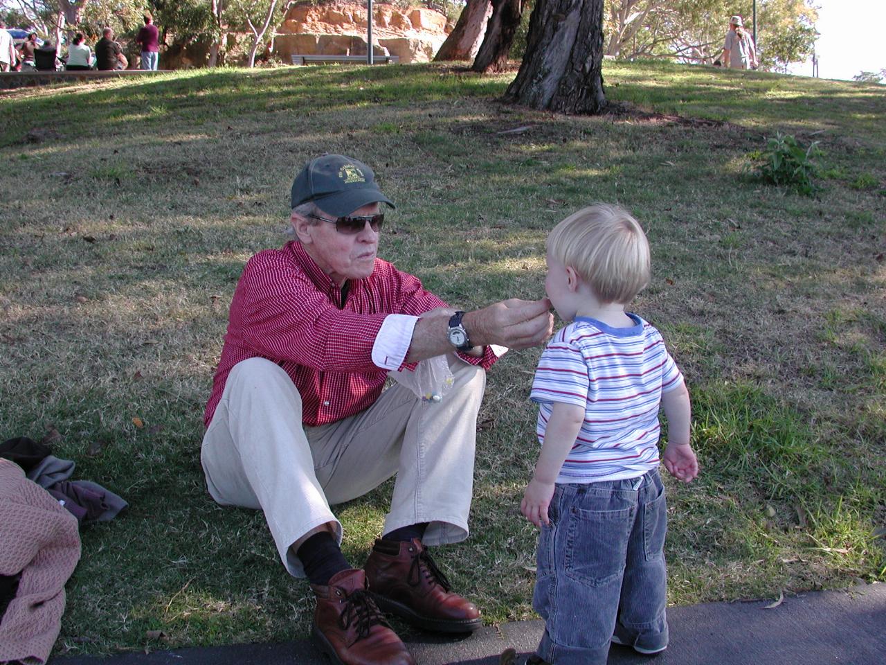 Flynn collecting a lolly from Peter.