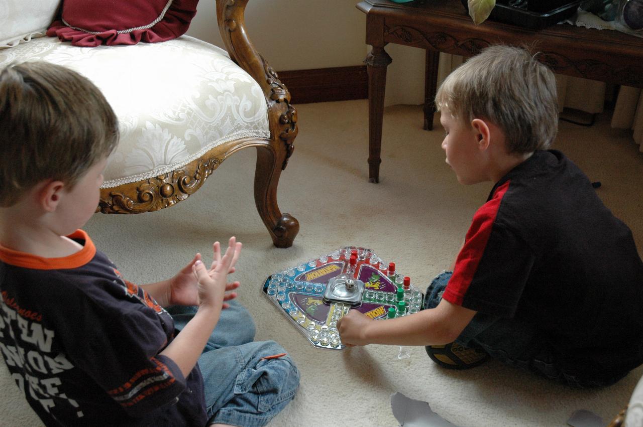 Jake Crofts and Tynan Wallace playing with Tynan's birthday present at farewell for Nat's return to London