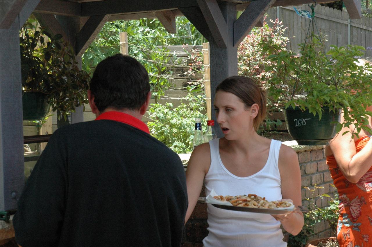 Peter (back to camera) and Natalie Currey around the barbecue before Nat's return to London