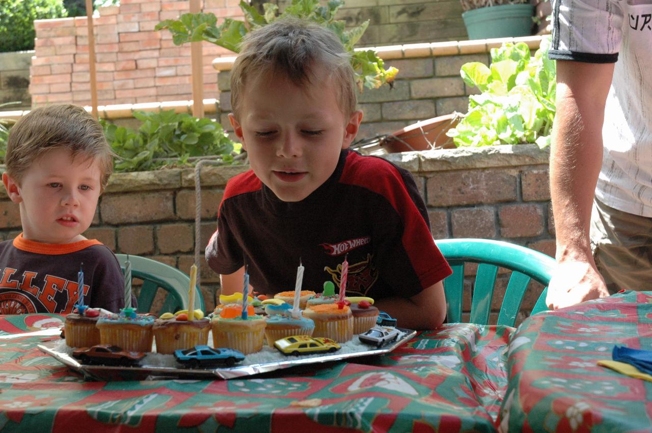 Tynan has blown out candles at his birthday during Nat's farewell to return to London; Jake looks on