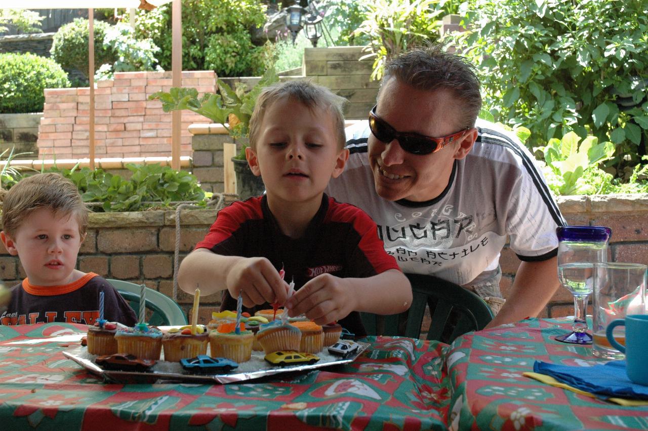 Proud Papa Glenn looks on as Tynan removes candles from his birthday cake at Nat's farewell before return to London