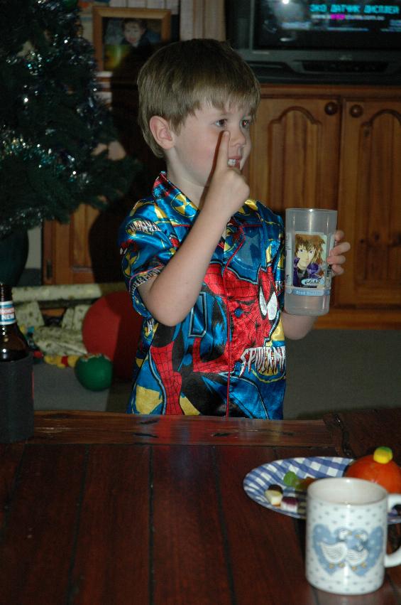 Jake Crofts with the drink for Santa's reindeer after Christmas Eve Mass at Woronora