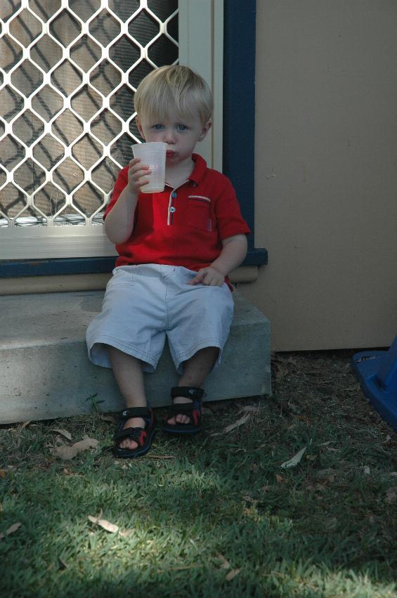 Flynn enjoying a drink on the back steps at Woronora on Christmas morning