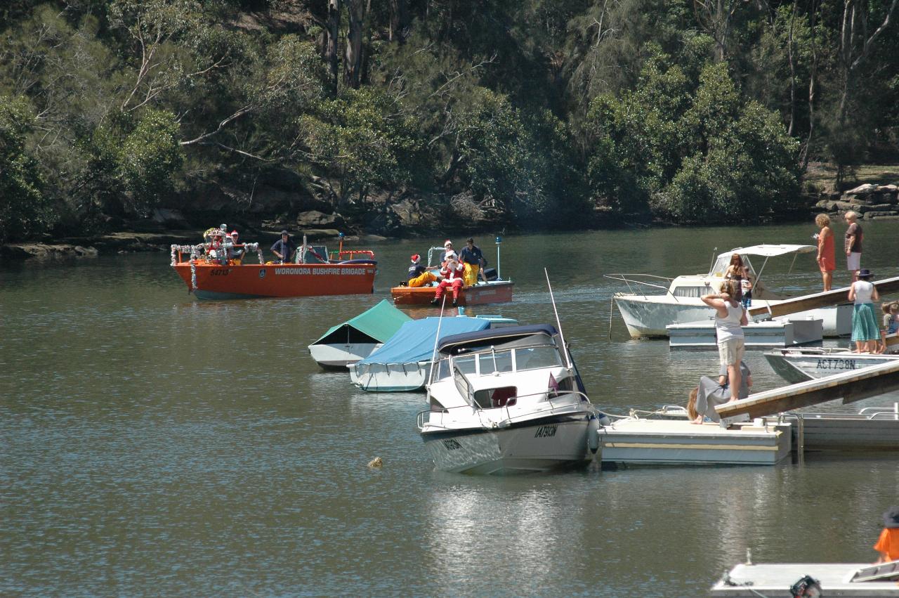 Santa arriving on fire boat on Woronora River on Christmas morning