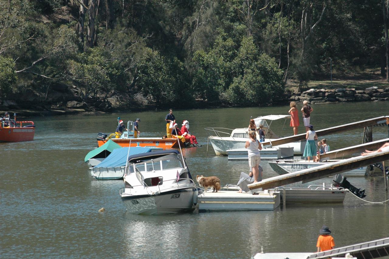 Santa arriving on fire boat on Woronora River on Christmas morning