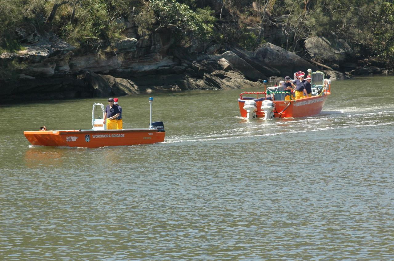 Santa's boat is now without Santa, who is walking down the beach on Woronora River on Christmas morning