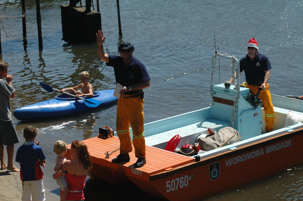 Peter Carter on Santa's boat talking to Cameron and Michelle and family on Woronora River on Christmas morning