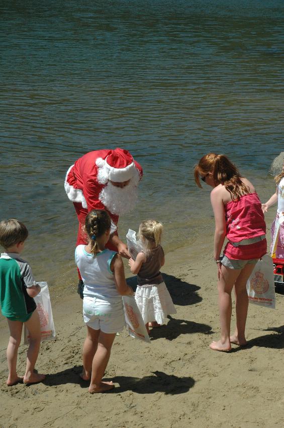 Santa and his helper collecting donations and handing out bags to the kids on Woronora River on Christmas morning