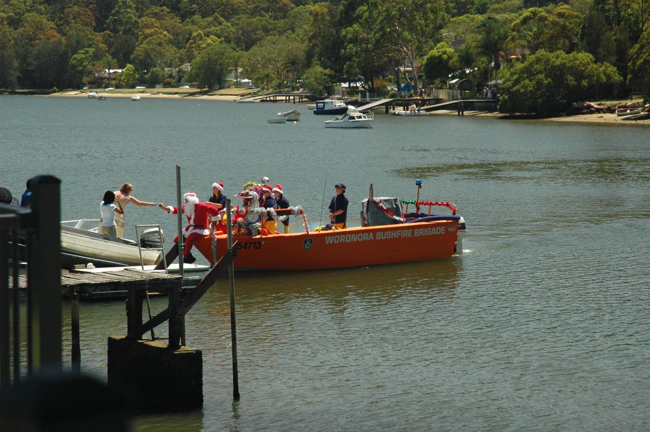 Santa's boat approaching a dock downstream from Cameron and Michelle's on Christmas morning