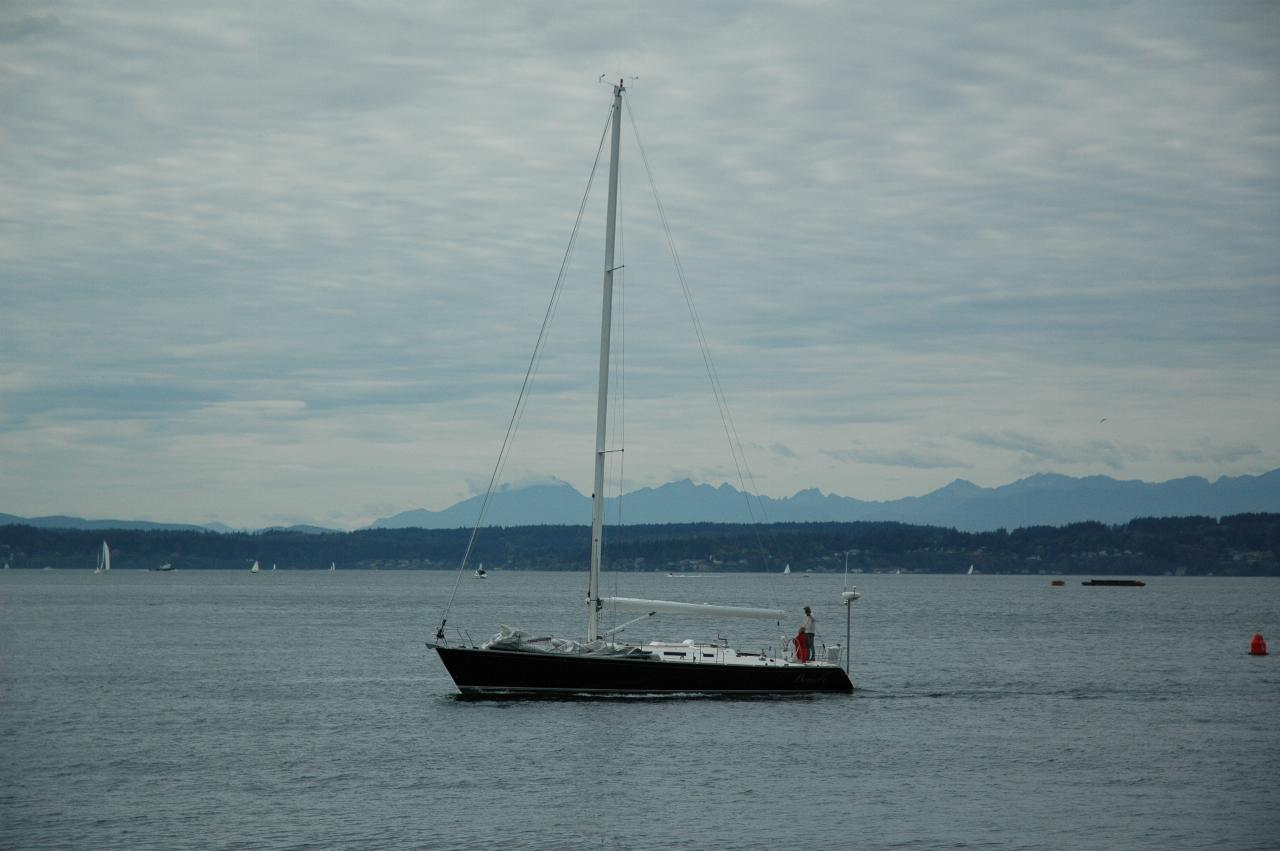 Nice boat approaching Ballard Locks from Anthony's Homeport at Shilshole with Olympic Mountains in the background