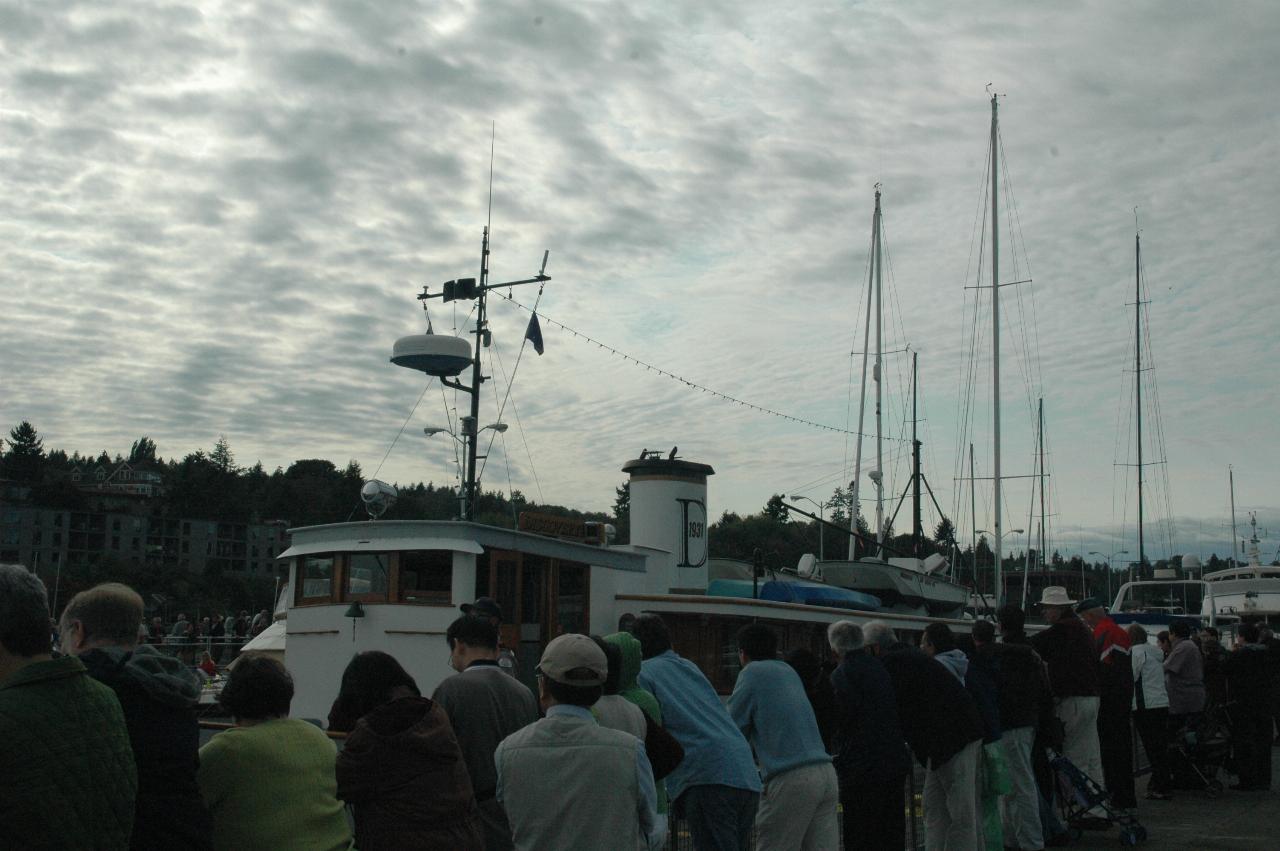 The wooden boat from earlier rising above the lock walls at Ballard Locks