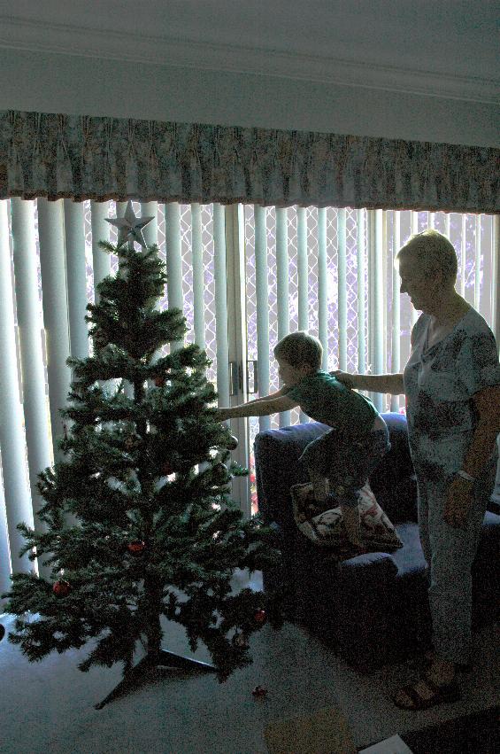 Jake helping Yvonne decorate Illawong Christmas tree