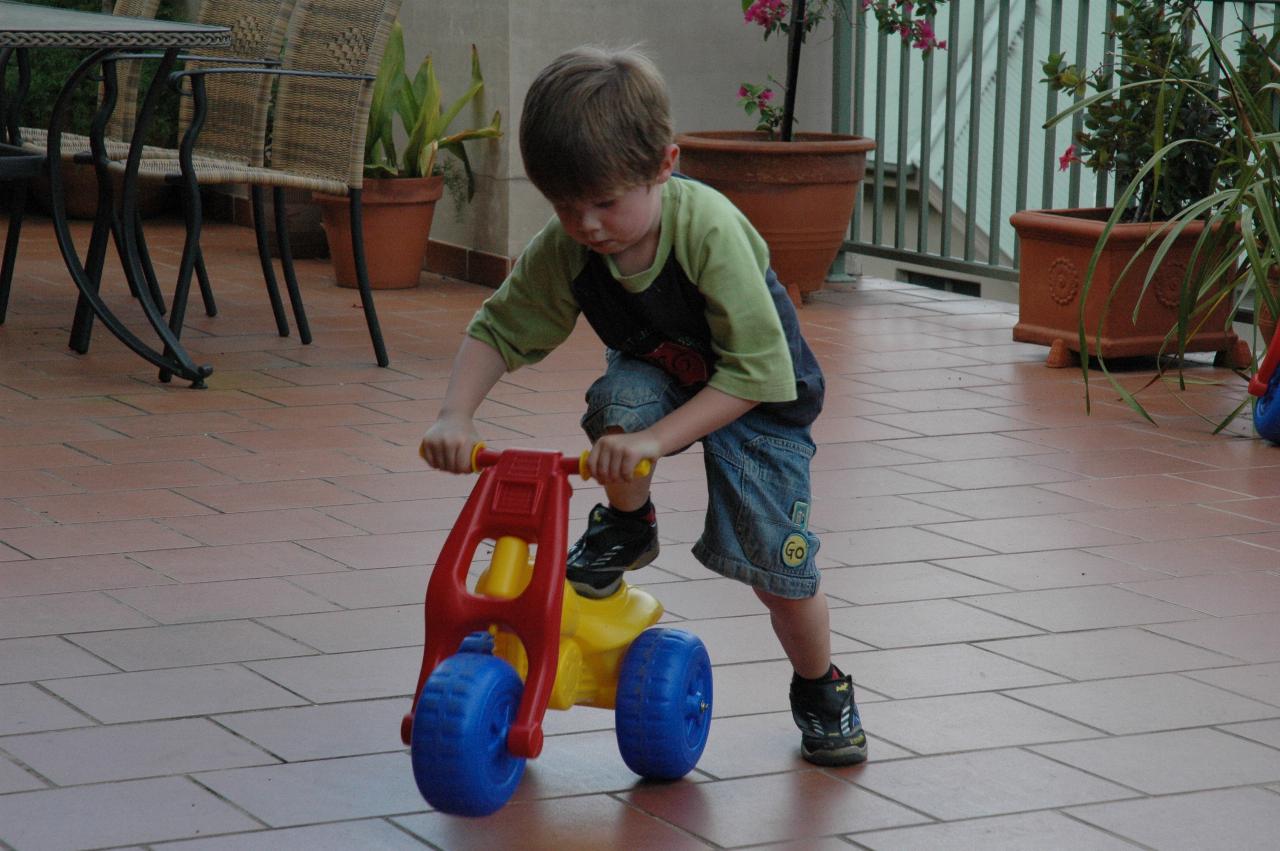 Jake Crofts riding his bike like a scooter on Illawong patio