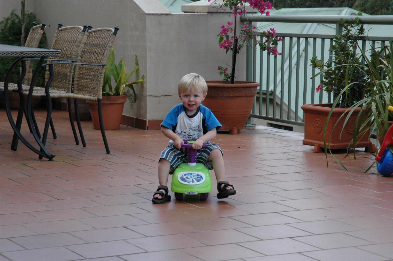 Flynn Crofts riding his bike on Illawong patio