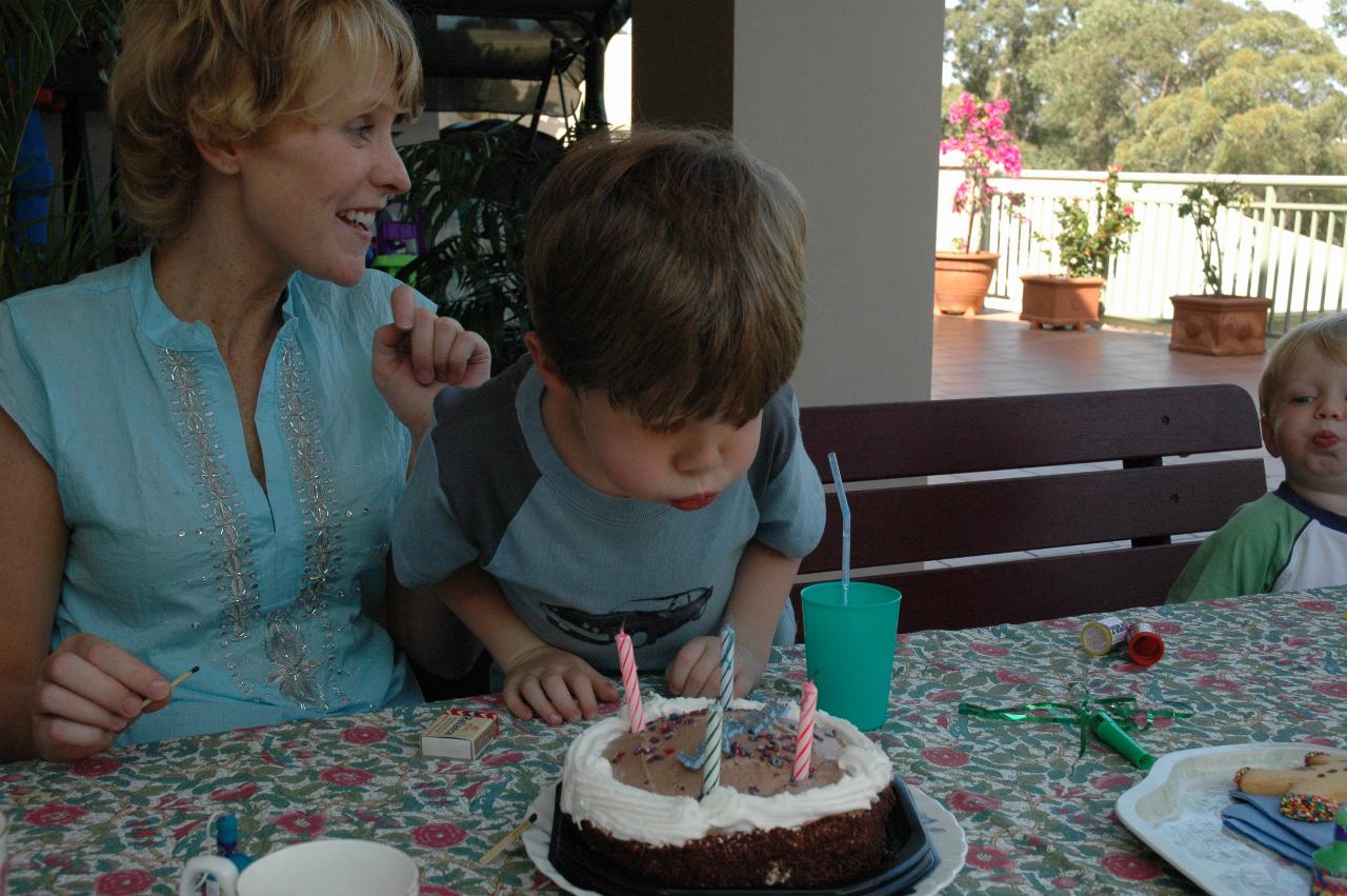 Jake blowing out the candles, Flynn helping at Michelle's quickie birthday party at Illawong