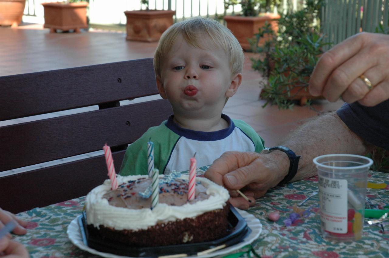 Flynn blowing out the birthday cake candles at Michelle's quickie party at Illawong