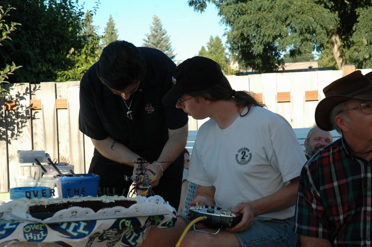 Seth adjusting his helicopter and discussing with Joe Warren