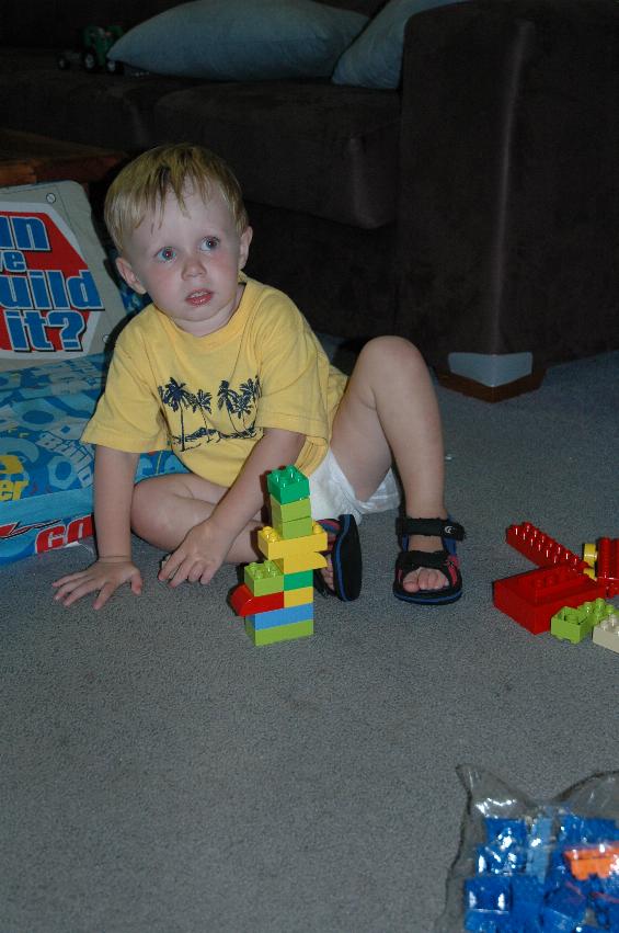 Flynn, with his blocks, watching TV at his second birthday party