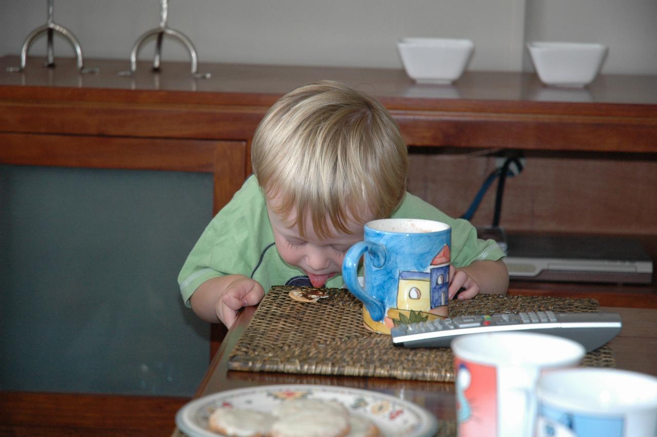 Flynn Crofts licking his biscuit and Vegemite