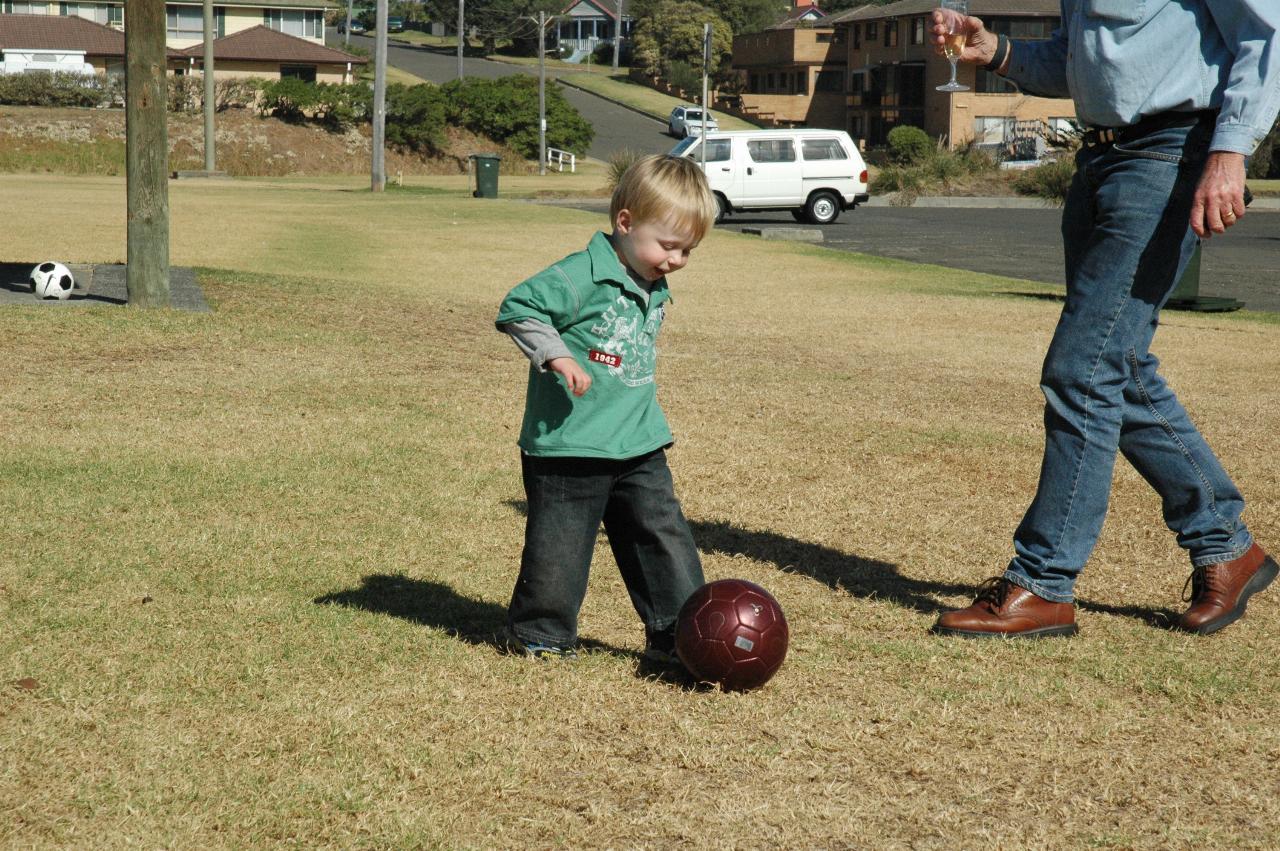 Mother's Day at Thirroul: Flynn learning to kick a ball