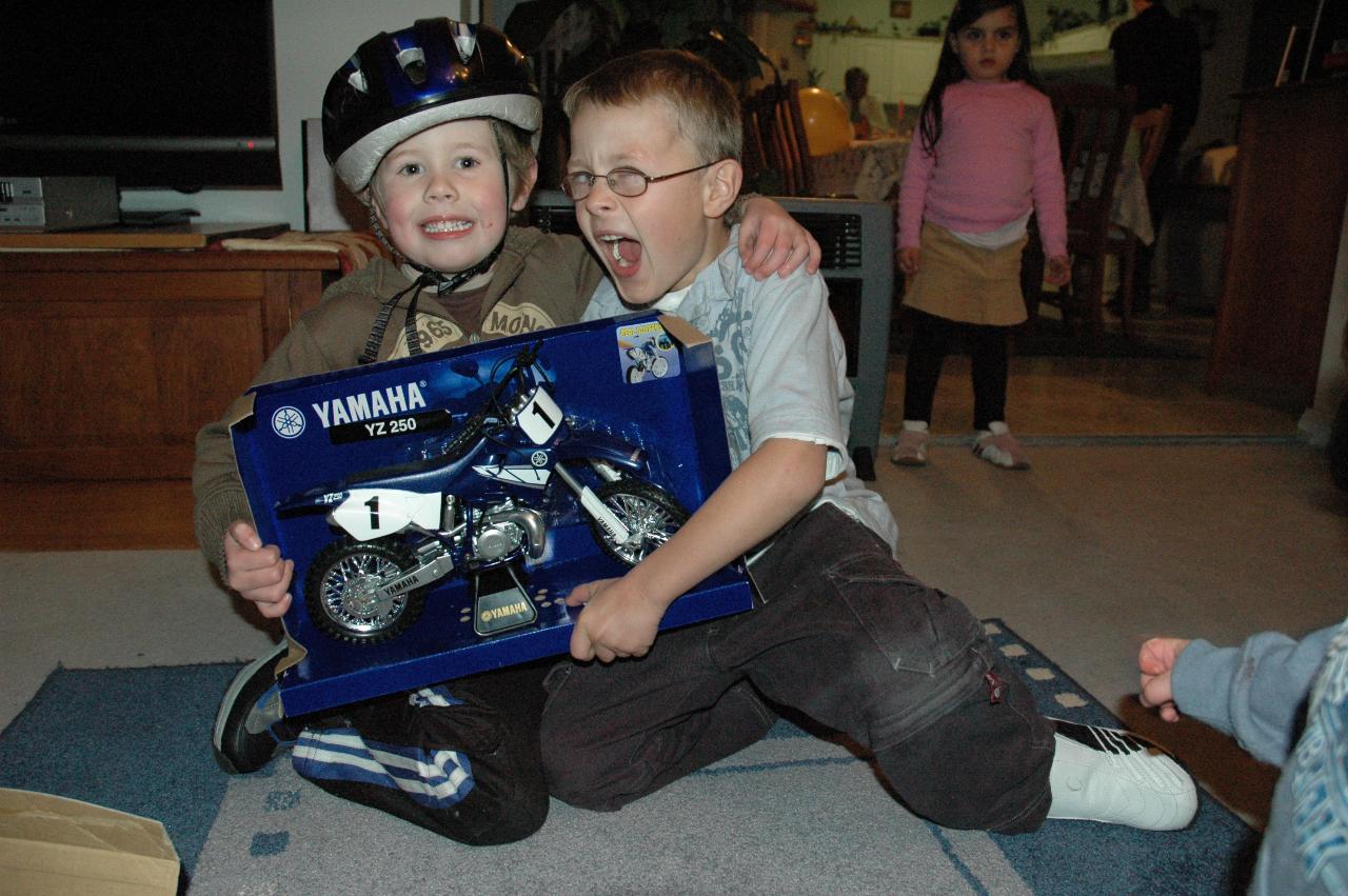 Jake's 5th birthday (Illawong): Jake and Tynan with Wallace's present; Taylor in background, Flynn's arm