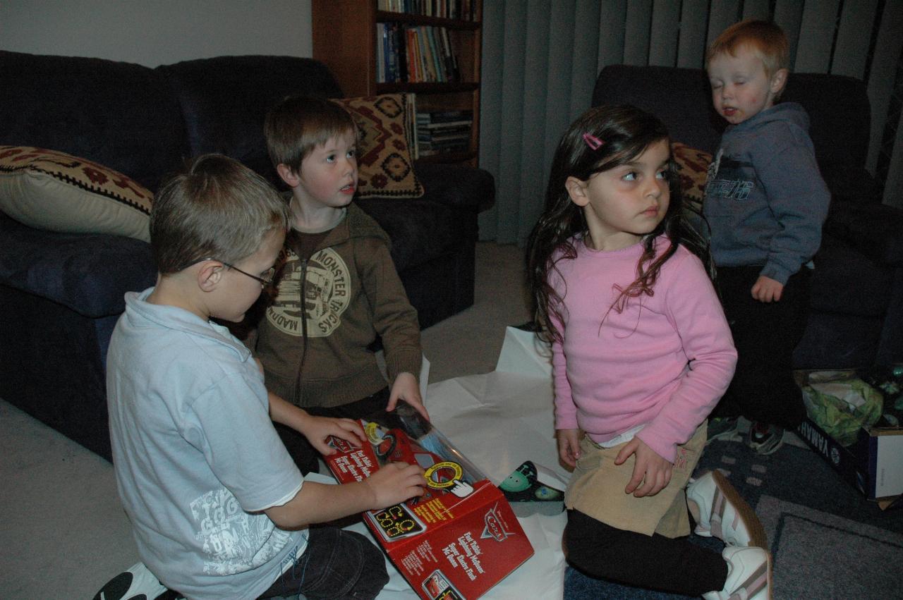 Jake's 5th birthday (Illawong): Tynan, Jake, Taylor and Flynn opening Jake's car present from Yvonne