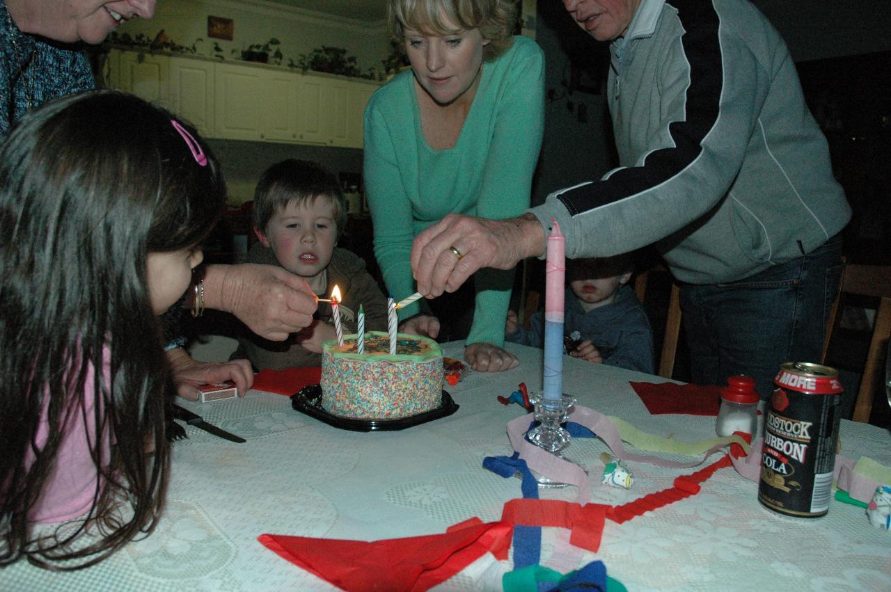 Jake's 5th birthday (Illawong): Yvonne and Peter lighting the candles