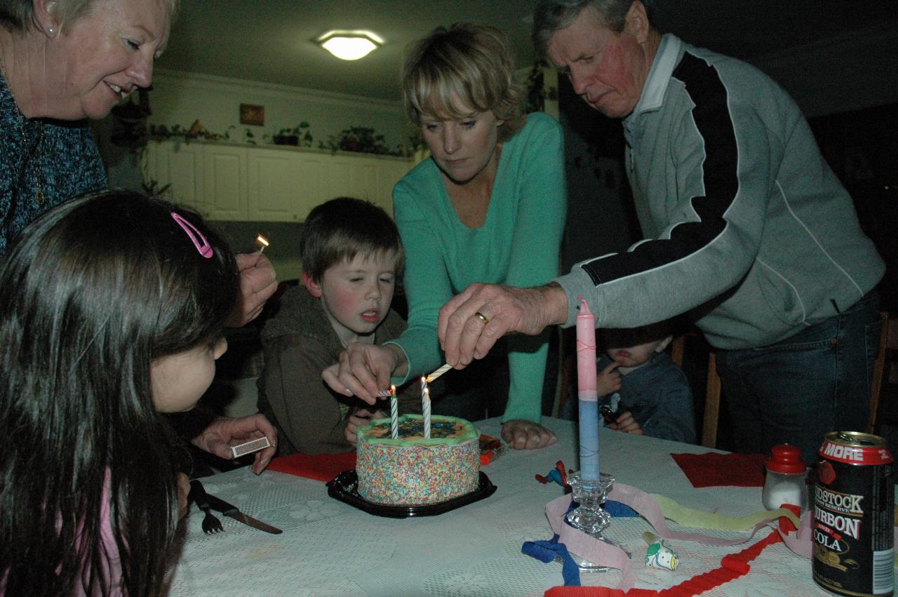 Jake's 5th birthday (Illawong): Yvonne, Michelle and Peter lighting the candles