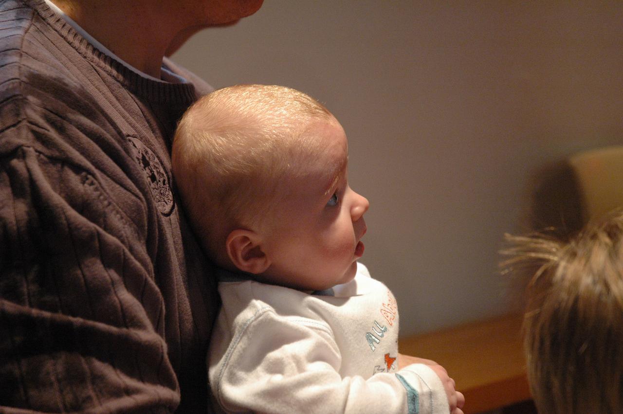 Cooper staring at Father Francis during his Baptism