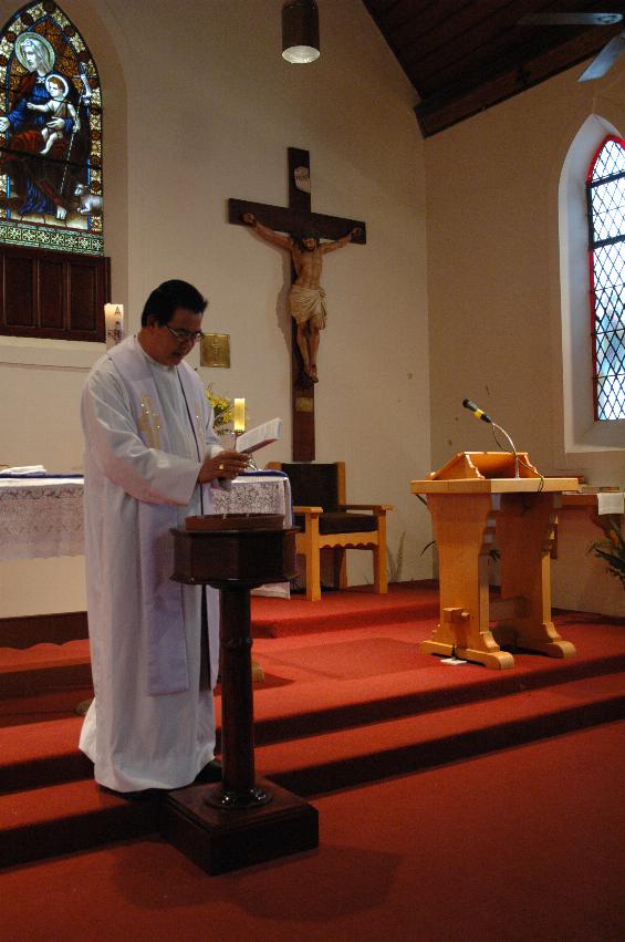 Father Francis blessing the Baptismal water